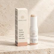 Stick Solaire Visage SPF50 Sans Teinte HOLIAĒ avec étui sur fond ivoire