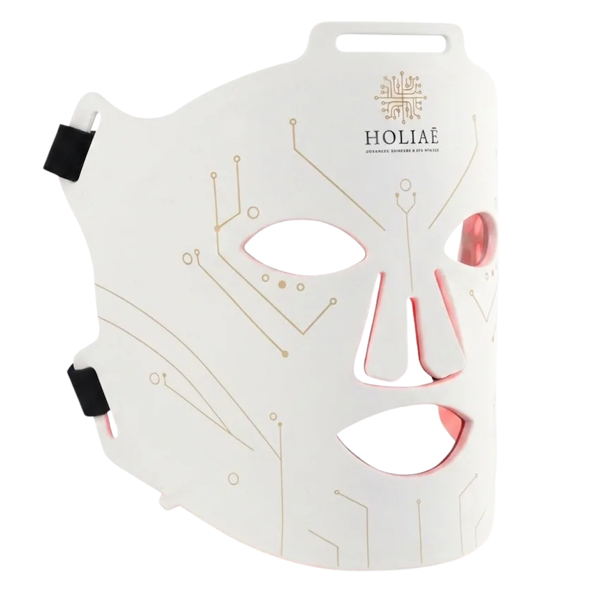 Packshot détouré du masque LED visage Holiaē RĒ:GEN I, circuits dorés et lueur périphérique.